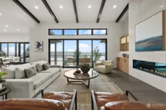 Relax by the fireplace and enjoy stunning views of the water, or step outside through the 10-foot sliding doors to fully embrace the scenic beauty.