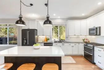 Full updated kitchen with a quartz top custom island