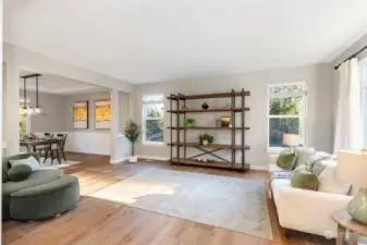 Front living Room is bright with natural light. Wide-plank warm tone engineered hardwood floors are stunning throughout the main floor.