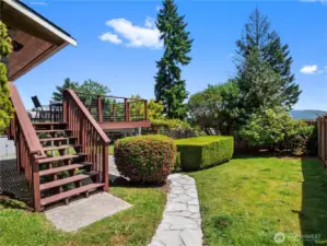 This property boasts a beautifully designed backyard, offering diverse outdoor living spaces.