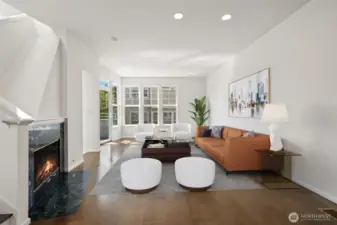 High ceilings, wood floors, tall windows, private balcony & gas fireplace on the main level! Open concept with kitchen, dining and breakfast bar - plus laundry and 1/2 bathroom! Virtually staged to show possibilities!
