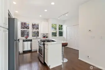 Updated kitchen with new stainless refrigerator, microwave, dishwasher & gas range.