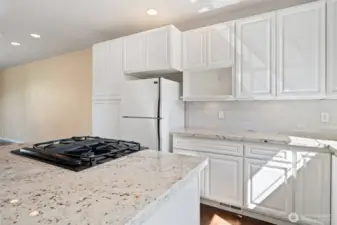 Bright kitchen with tall windows, ceiling spots and more.