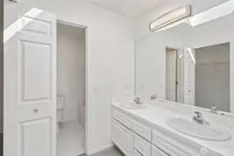 Primary bathroom with 2 sinks, new lighting, large walk in closet, fresh paint and new carpets!
