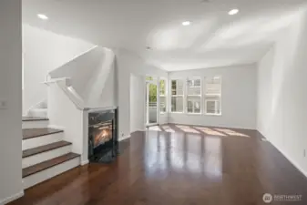 Main level showing stairs up to primary suite and extra bedroom and bathroom. 1/2 bath up the 3 stairs to the left for easy access from the kitchen and main living areas.