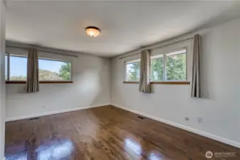 This angle in the primary suite shows the large windows that the room offers that bring a lot of the outside in.