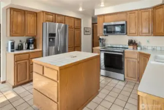 Kitchen with new stainless steel appliances.