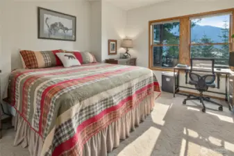 Primary bedroom with views of lake and mountains.