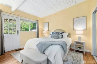 Vaulted ceilings over the primary with door to backyard