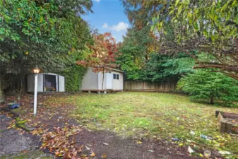 Large and private backyard with 2 storage areas, garden beds