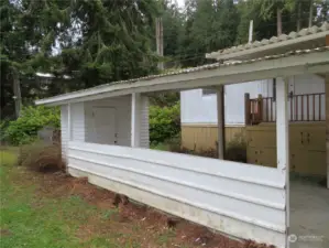 Carport and shed.  Wooded backyard, then beyond that W. Lake Samish Dr.