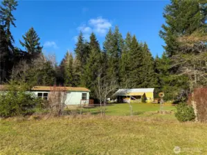 Partially fenced field near home & shops