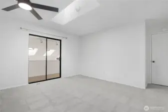 Primary bedroom showing sitting area and entry door on right.