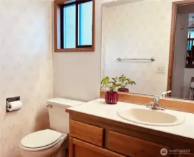 Front large size powder room by foyer entrance.