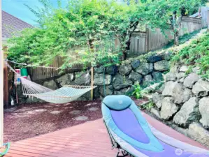 Personal lounging oasis with hammock easily converted to a clothes line for drying to conserve energy.
