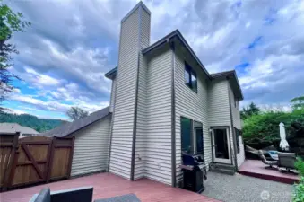 North side of home looking south with freshly painted siding on tall chimney.