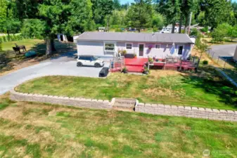 Back of home w/expansive deck & beautiful yard