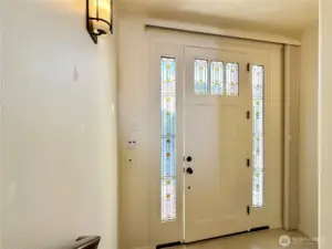 Front door landing with stairs going up to the great room or down to the garage.