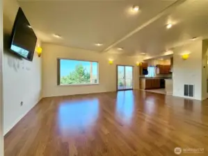 Open and airy great room with sliding door leading to the covered deck. Laminate flooring in great room and bedrooms.  Tile floors in entry, kitchen, and bathrooms. Wool carpet in stairs.