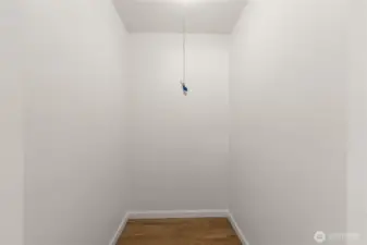 Spacious walk-in hallway closet providing ample storage for coats, linens, and household essentials