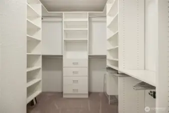 Primary walk in closet with built in organizers.