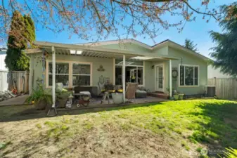 Back of house with large covered extended patio