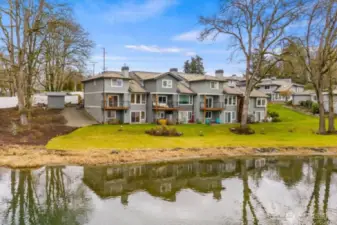 Truly at the "Water's Edge", this large condo (the left unit in this photo) sits on the bank of beautiful Lake Steilacoom.