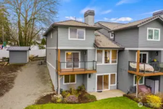 Look at all the windows with fantastic lake views! The balcony here is on the main level of the home. The upper window is the primary bedroom. On the lower level is a large bedroom with full bath, or a large den/office, plus a family room with slider to the patio. Notice the heat pump on the upper left side of the building.