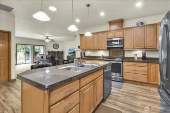 kitchen that boasts New Stainless Steel Appliances, walk in pantry, abundant cabinet storage, tons of counter space, and Large Island with room for bar stools