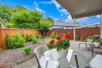 Fully fenced in back yard with covered patio