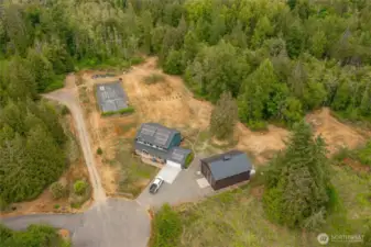Ariel view of home, shop, fenced garden, orchard and acres of woods.