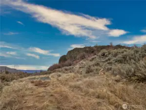 Lower tier north view has shale and level space for RV/camper trailer parking