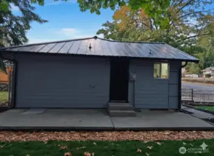 Side yard that feels like a private backyard — clean concrete patio, easy access from the laundry room, and space for a grill or cozy outdoor setup. Simple, practical, and easy to maintain.