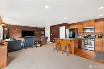 Open-concept main floor connects living, dining, and kitchen areas, maximizing space and natural light.