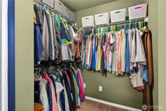 Large walk-in closet with shelving offers excellent storage and organization.