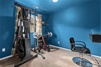 Flexible bedroom space currently used as a home gym, ideal for fitness or workspace.