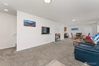 Living room with stairs to the left, 1/2 bath & storage in front and dining room to the right.