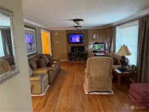 Looking at the living room from the dining room. Entrance to the right.