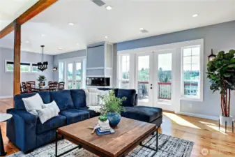 The living room space opens comfortably to the kitchen/dining areas as well as to the outdoors.