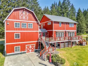 From the back side of the house you can see the large patio, the doors under the garage to the flex space, the back deck complete with motorized awnings, and that hot tub just waiting for you. There is so much possibility for enjoyment here!