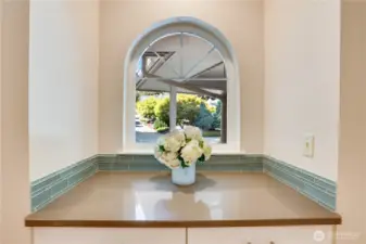 Built-in shelving and framed window over looking the front yard.