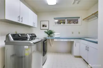 The thoughtfully designed utility room, boasting generous storage and a convenient prep-sink.