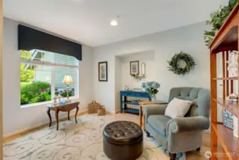 Upon entering, you’re greeted by a welcoming formal living room—an elegant space with large windows that fill the room with natural light.