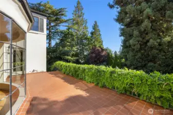 You can enter this fabulous terrace right off of the dining room.  Plus, there are stairs leading down to the backyard.
