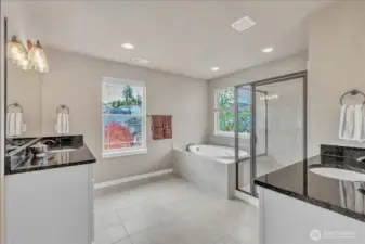Ensuite primary bathroom with luxurious soaking tub & over sized shower.