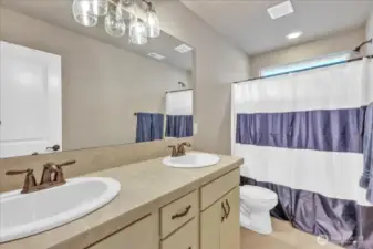 Upstairs guest bath with bathtub and shower.