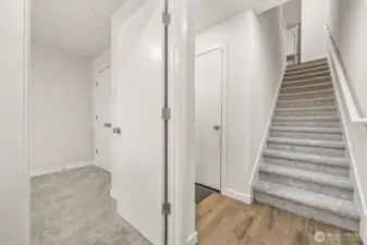 Inside front door is first bedroom and garage access.