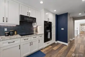 Easy to use Induction oven, along with a double oven and attached microwave. Pantry with plenty of room and pull-outs along with another pantry around the corner!