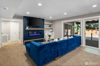Newer electric fireplace so easily sets the mood when you dim the lights and watch your favorite movie or series!  Surround sound and custom cabinetry.  Plenty of space for the big couch or movie chairs!