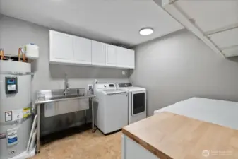 Two new hot water tanks, this is one of them!  Full Laundry room, washer and dryer stay along with a large half freezer!  Full size sink as well.  Smart wiring sytem for house located in cabinetry.